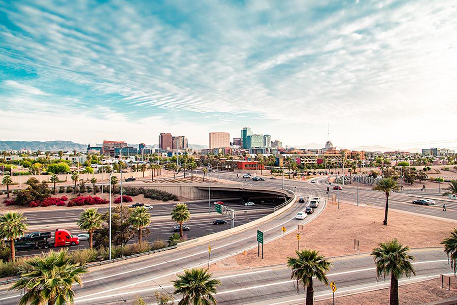 Phoenix, AZ Insurance - Phoenix Arizona Highways, Palm Trees, Skyline and Blue Sky With Wispy White Clouds